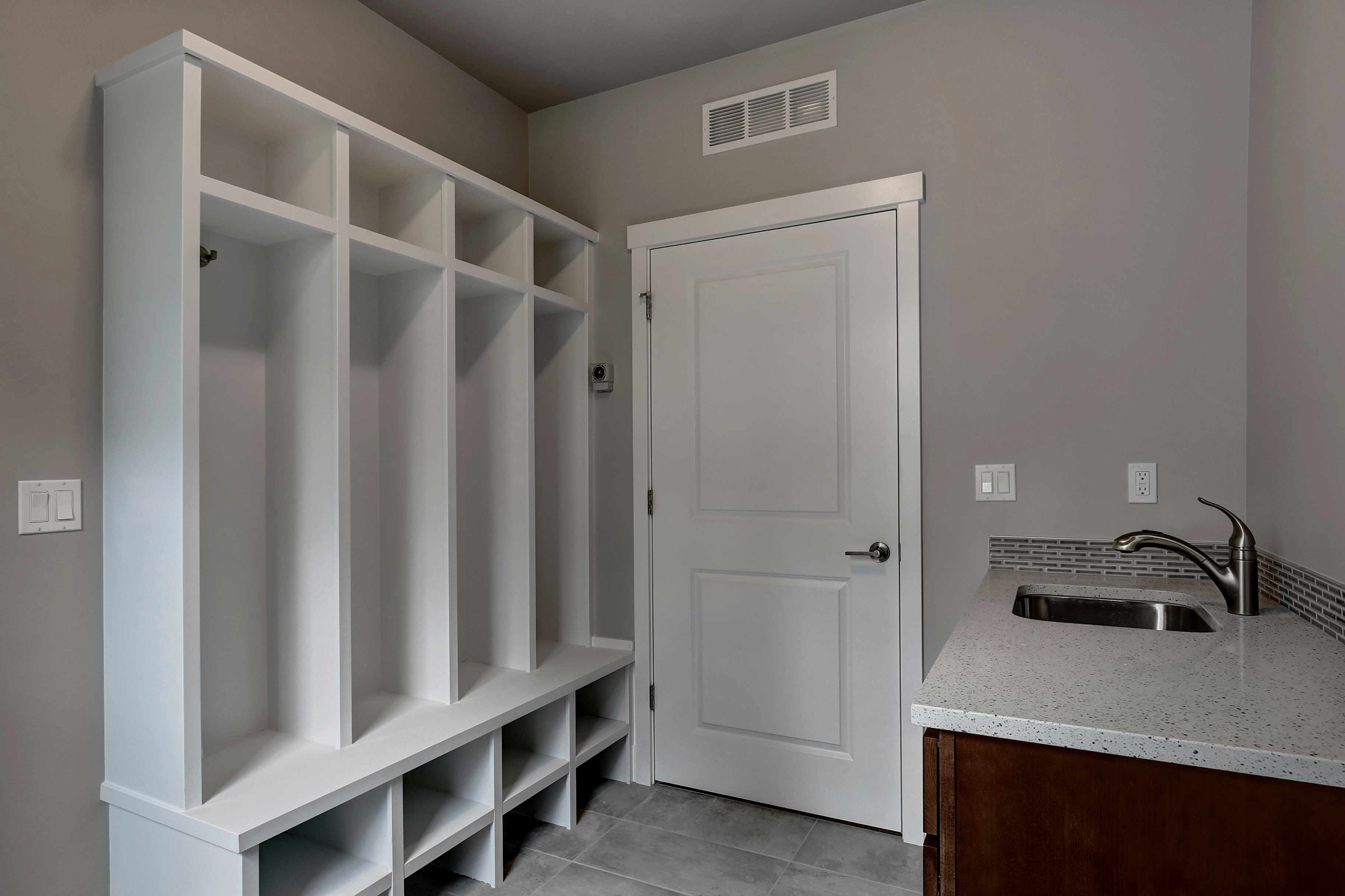 Mud room with built-in cubbies and sink